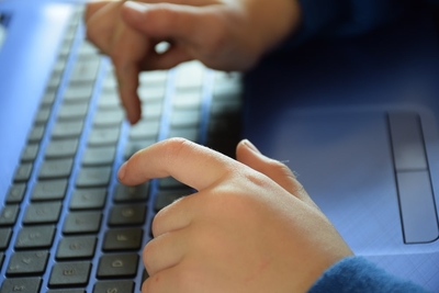 Person Typing On A Keyboard