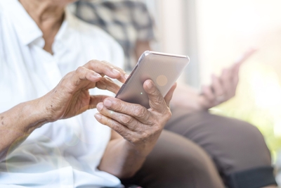 Photo of an Elderly Person Using Mobile