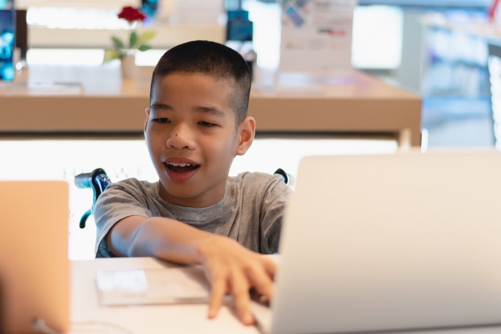 A Child Working With A Computer
