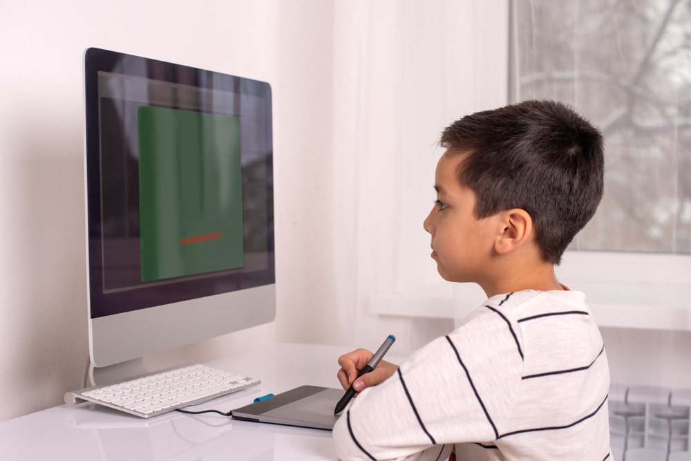 A Child Drawing A Line On Computer