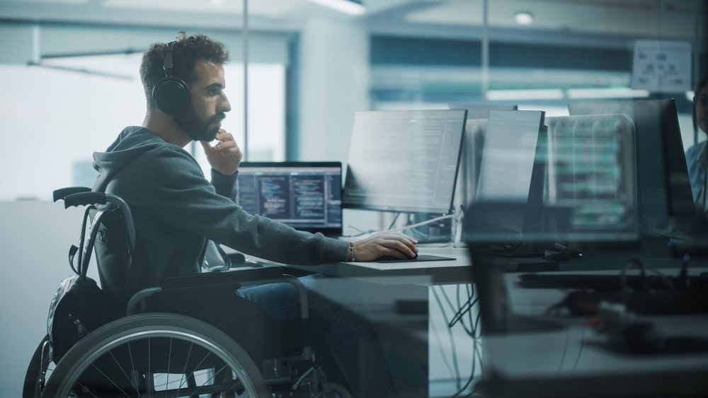 Person In A Wheelchair Working On A Computer